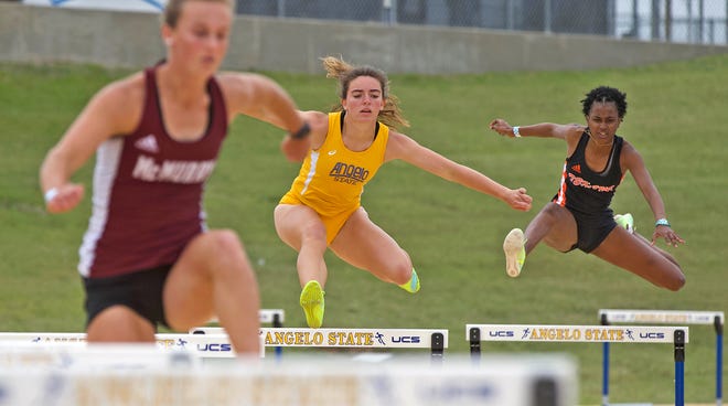 A runner for Angelo State University, center, competes in a hurdles event during the David Noble Relays track and field meet Friday, April 2, 2021.