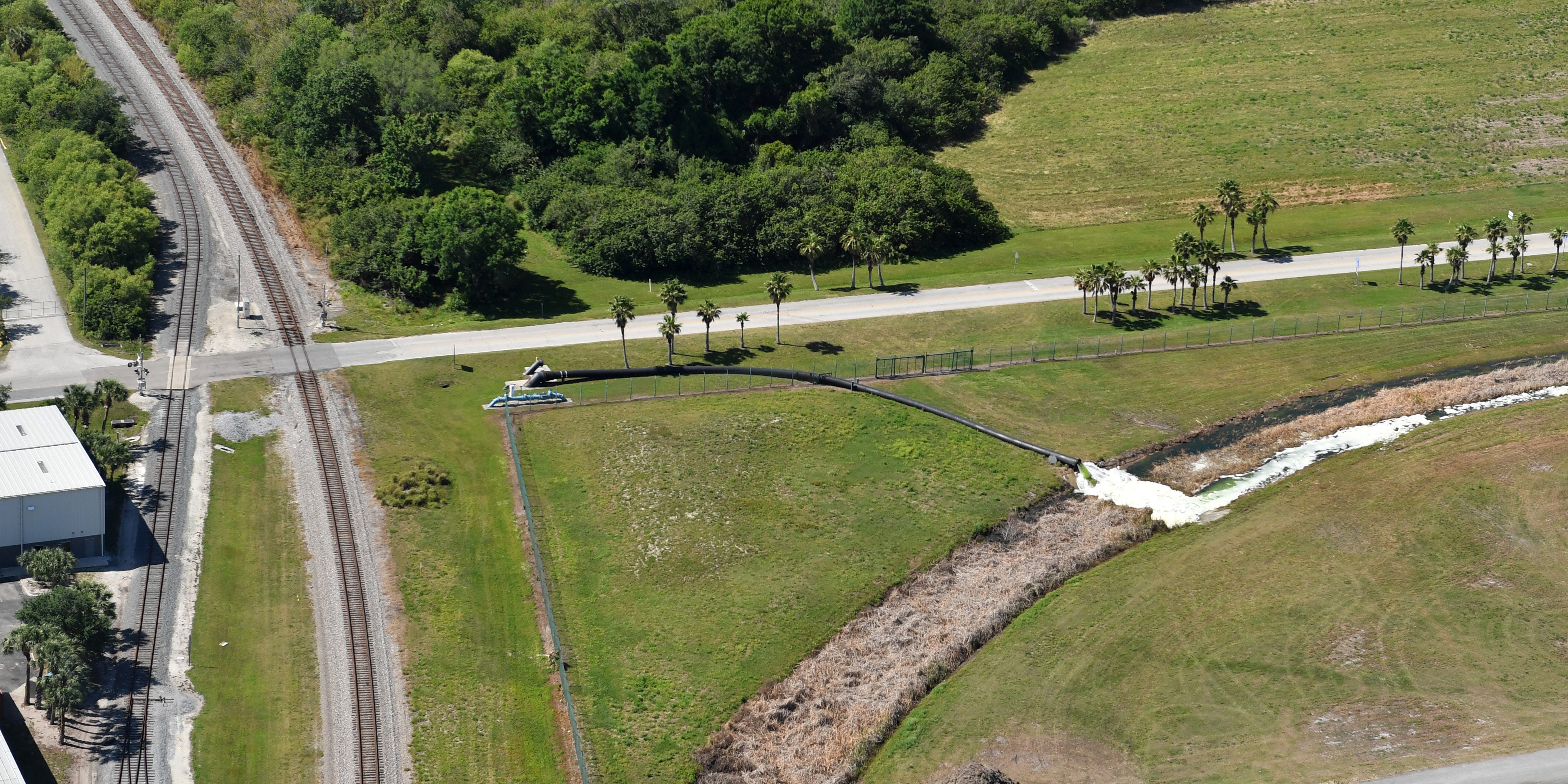 Wastewater being pumped from the Piney Point reservoir flows into this ditch and into Tampa Bay. United States Congressman Vern Buchanan toured Piney Point Monday, Apr. 5, 2021, getting a look at the breach in the containment wall, the pumping outflow and Port Manatee where the wastewater is being pumped into Tampa Bay.