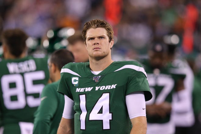 New York Jets quarterback Sam Darnold (14) reacts on the sideline during the fourth quarter against the New England Patriots at MetLife Stadium.