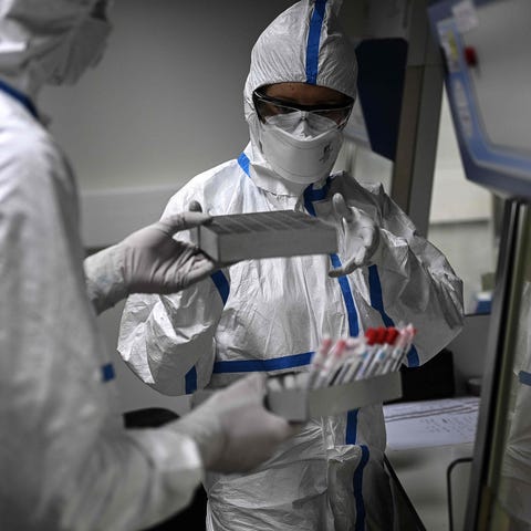 Laboratory technicians wearing protective equipmen
