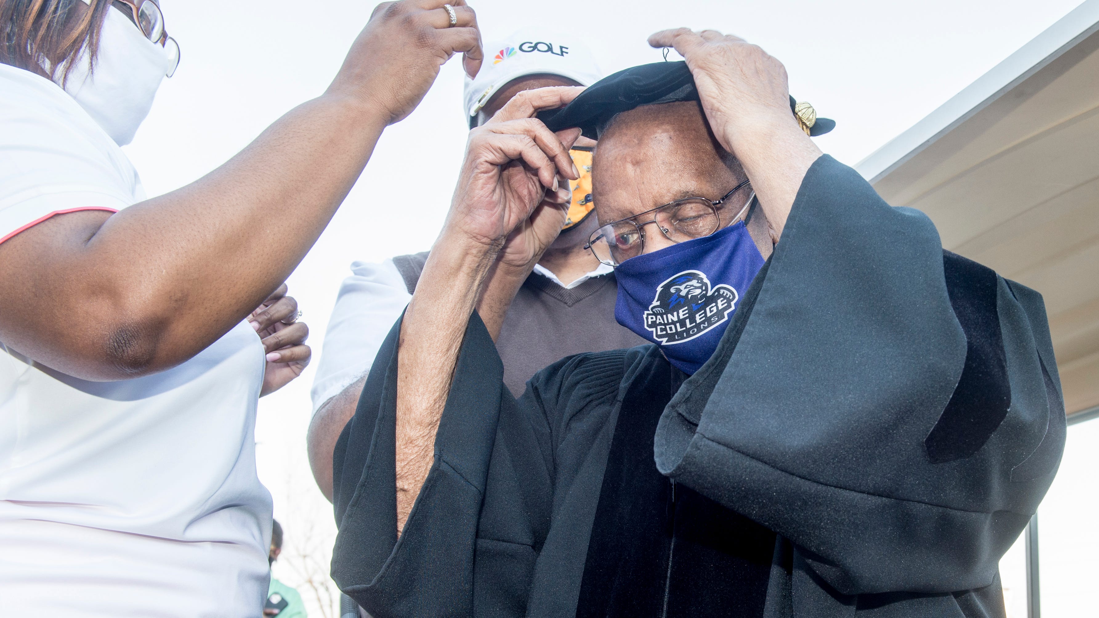 After donning his robe, Lee Elder places his graduation tam on his head during Tuesday's honorary doctorate ceremony at Paine College.