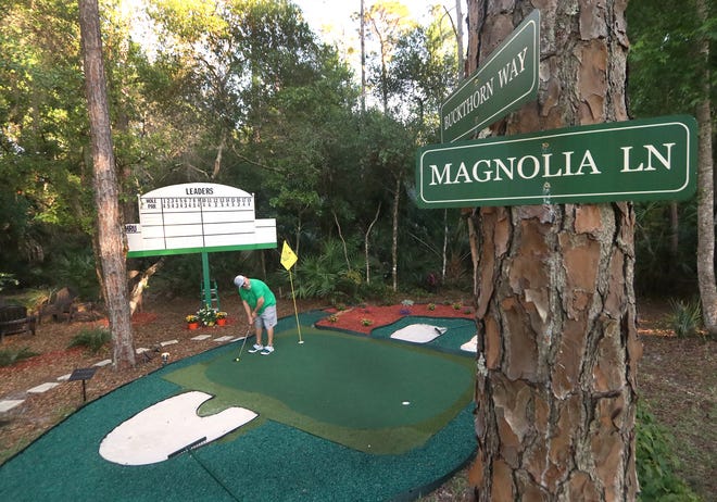 Tommy Craig putts on his replica of Augusta National's 12th green, part of the Masters Tournament "shrine" in the backyard of his Ormond Beach home.