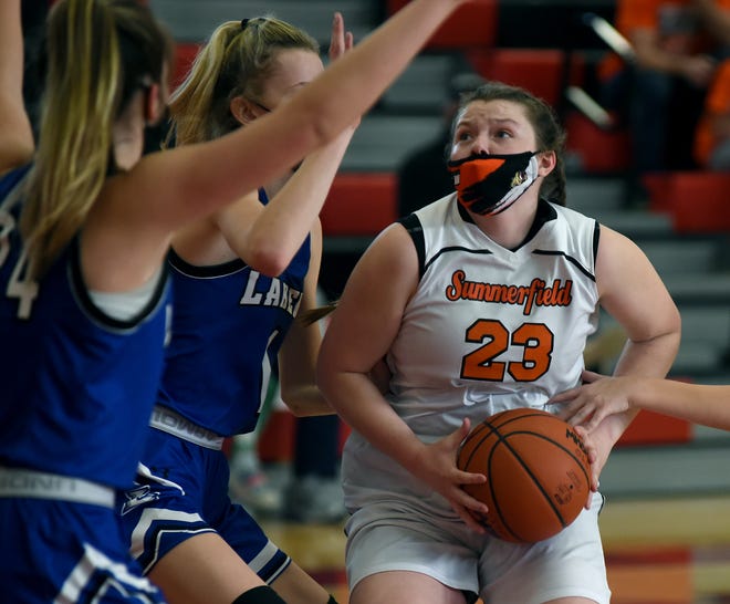 Abby Haller of Summerfield looks to go to the basket against Quinn Bobak and Brooklyn Robak of Waterford Our Lady of Lakes in the Division 4 quarterfinals held at Lake Shore High School Monday.