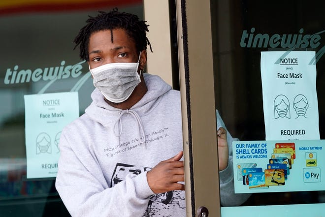 A man leaves a convenience store while wearing a required face mask in Houston on June 25, 2020. Although nearly a fifth of U.S. states don't require people to wear masks to protect against COVID-19, some businesses are requiring employees and customers to be masked on their premises. [AP file Photo/David J. Phillip]