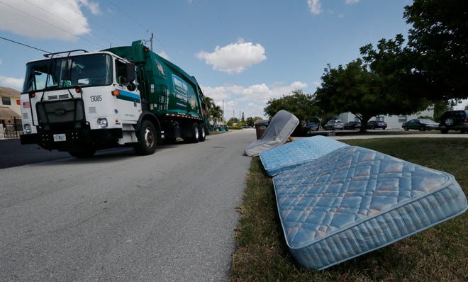 A Waste Pro garbage truck collects trash along a neighborhood south of Cape Coral Parkway Monday, April 5, 2021. Cape Coral residents have been upset with their trash not being picked up.