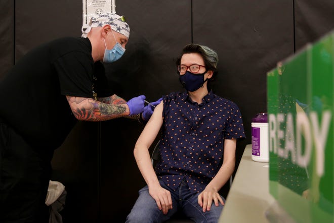 Alex Seto, a Purdue University graduate student, receives a Pfizer-BioNTech COVID-19 vaccine shot at the Purdue University vaccination clinic, Tuesday, April 6, 2021 in West Lafayette. Seto serves of the Purdue graduate student government chief of staff.