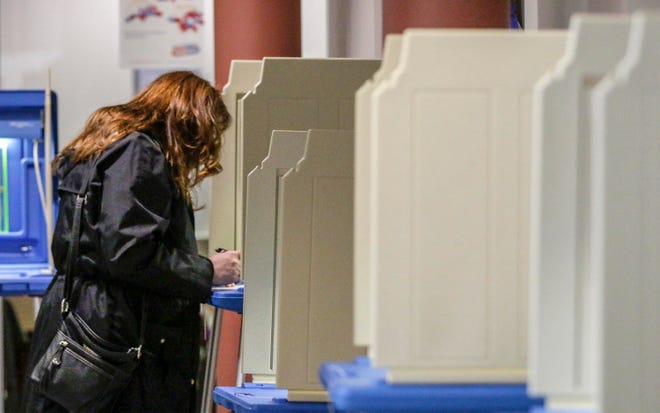 Kim Freeman, of Two Rivers, works on her ballot at Grace Church poll, Tuesday, April 6, 2021, in Manitowoc, Wis.