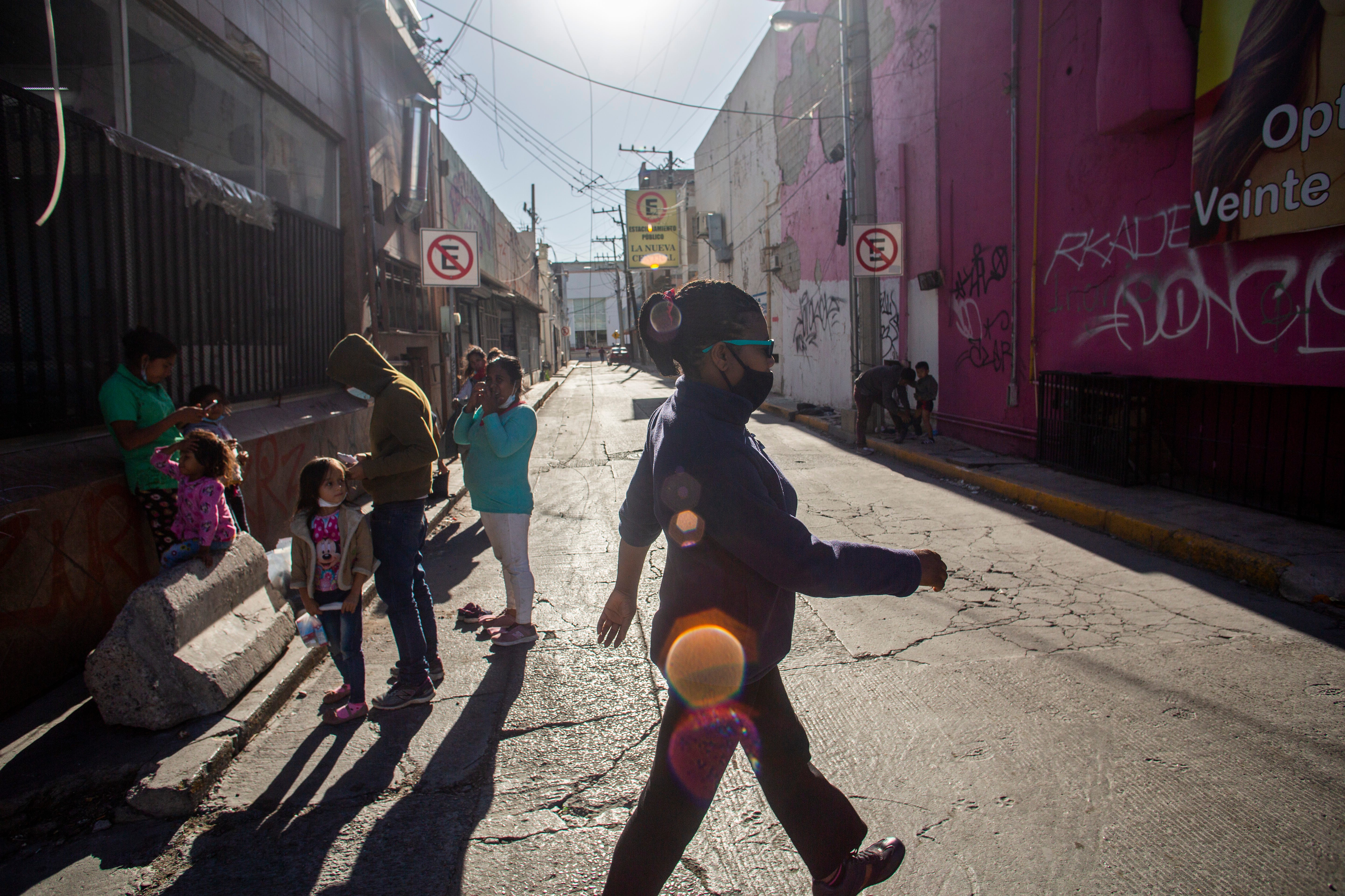 Marie Martine walks in downtown Cuidad Juarez past Central American migrants near the Paso Norte Bridge. 