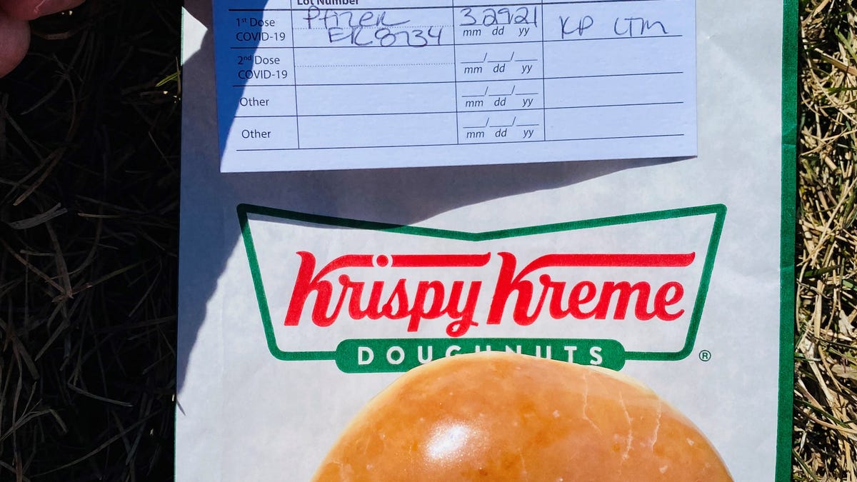 Debbie Nelson, a Denver-area resident, celebrated getting the first dose of her COVID-19 vaccine by showing her vaccination card at Krispy Kreme to receive a free donut.