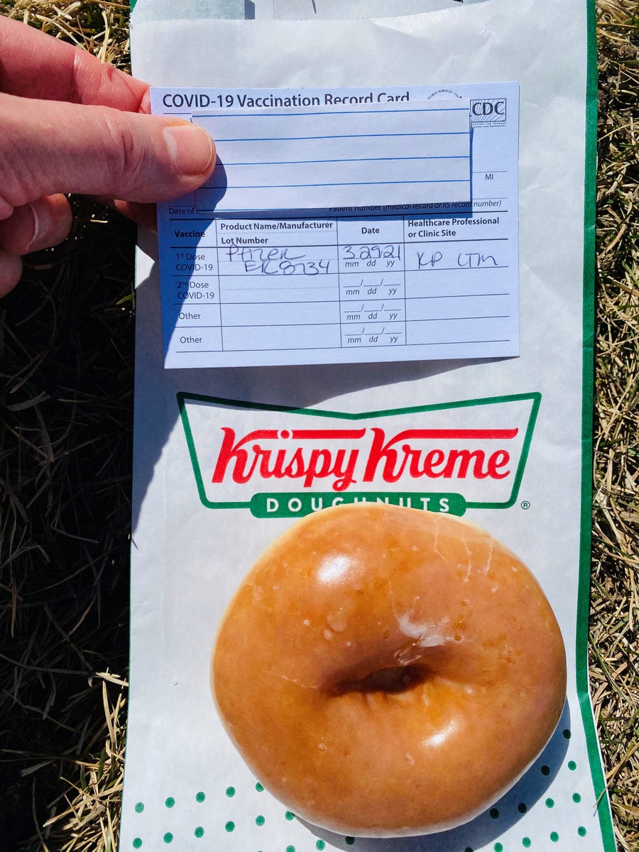 Debbie Nelson, a Denver-area resident, celebrated getting the first dose of her COVID-19 vaccine by showing her vaccination card at Krispy Kreme to receive a free donut.