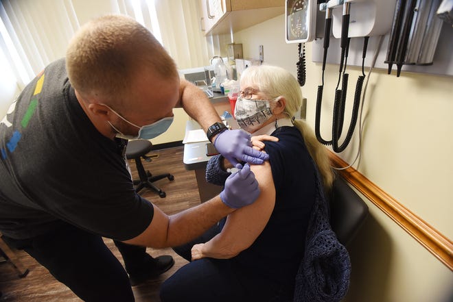 Nurse practitioner Alex Tatangelo gives Linda Schlafer, of Monaca, the Pfizer COVID-19 vaccine Wednesday at Central Outreach Wellness Center in Aliquippa.