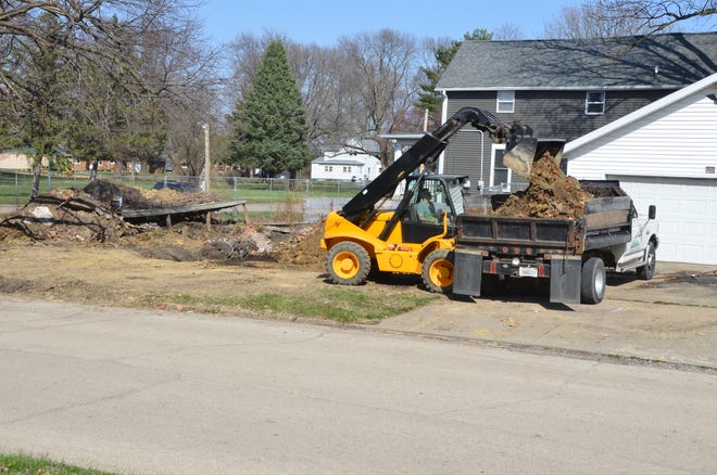 Paul Stutler was photographed taking advantage of the spring weather to work on his new home Tuesday.
