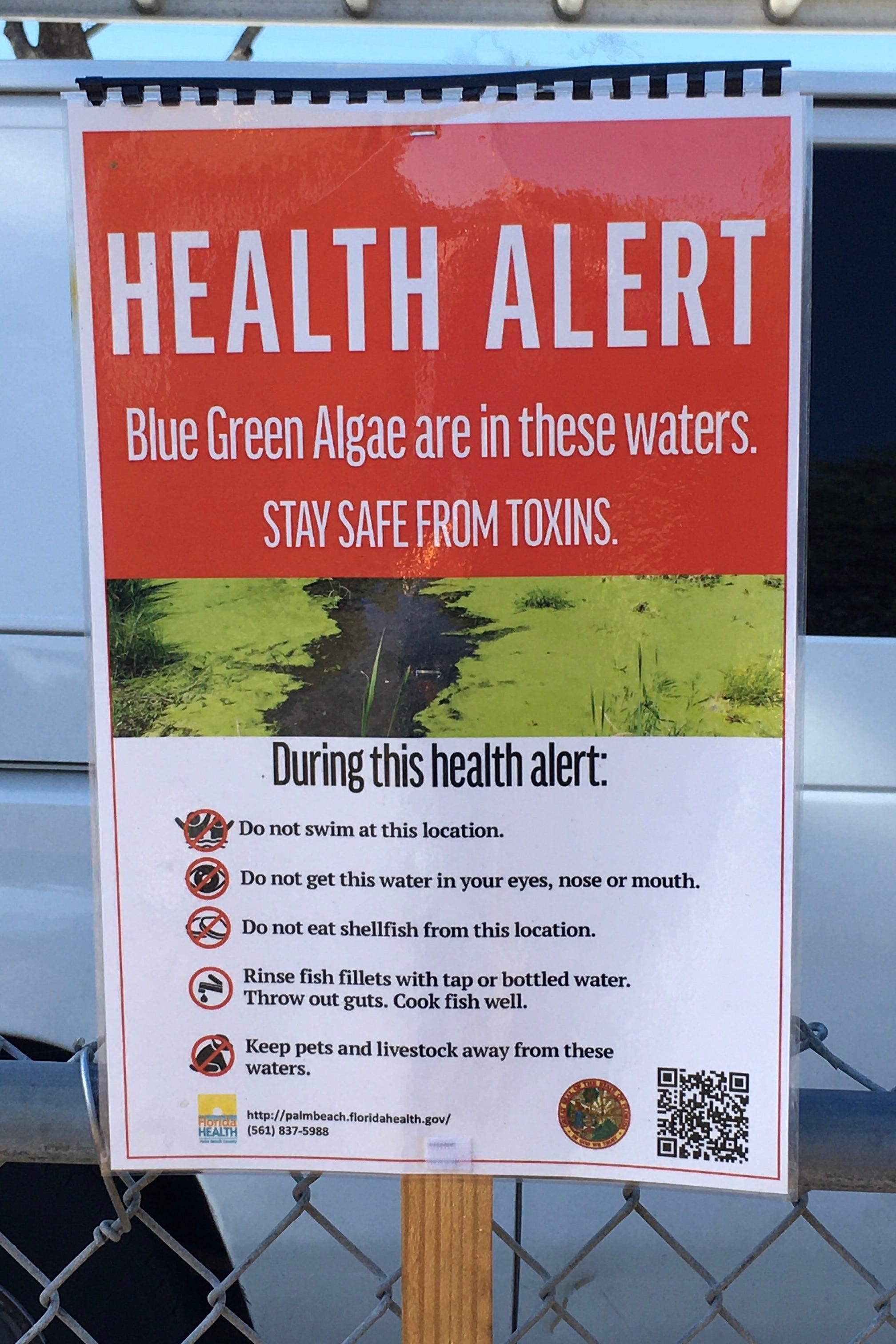 Signs posted last month at the spillway between Lake Worth and West Palm Beach warn of blue green algae that was found in water being discharged into the Lake Worth Lagoon.