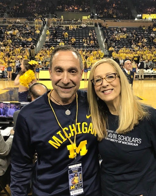 Michael Nathan and his wife, Lauren, attend a Michigan basketball game at Crisler Center.