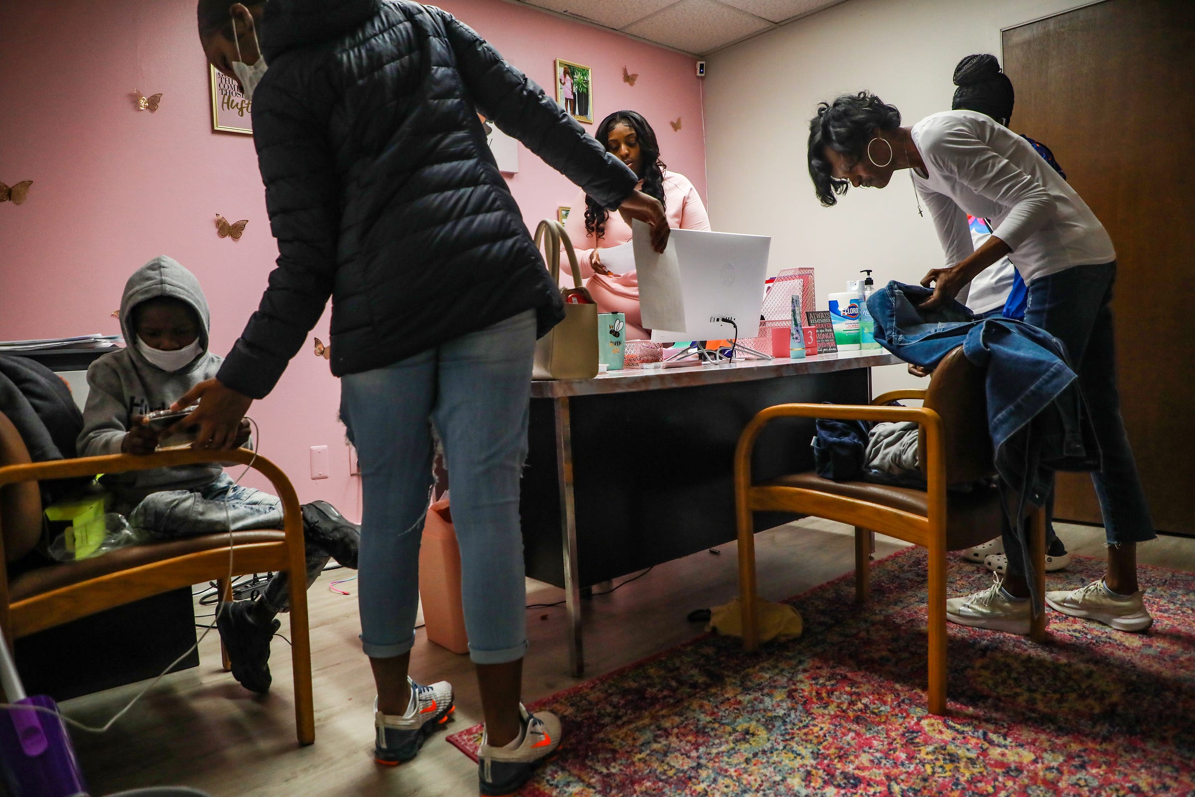 Tyra Moore, founder of A Girl Like Me, Inc. non-profit, center, talks with Marilyn Williams, 50, of Detroit, right, and her two daughters, Amaray Peterson, 15, left, and Rayne Peterson, 13, during the mentorship class held every Saturday in Southfield on March 13, 2021. Moore says she started the non-profit for her daughter and wants to serve young girls and help them navigate growing up with loss, stress and puberty. Williams and Moore met when their daughters, Rayna and Samari became close friends playing volleyball together. "We're like big sisters to them," says Moore, "if they don't have anyone to talk to, they can always talk to us about anything that may be going on in their life."