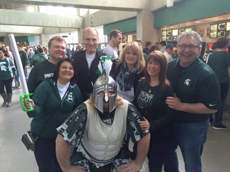 Kathy Stiffler, third from right, hangs out with friends from the Upper Peninsula during halftime of a Michigan State basketball game at the Breslin Center.