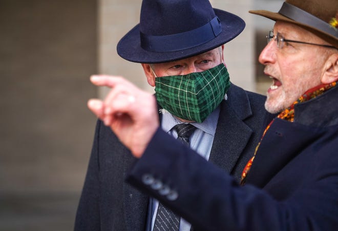 Richard Baird, center, former top adviser to Michigan Gov. Rick Snyder, listens as his attorney Randall Levine addresses the news media after he exits the Genesee County Jail in Flint on Thursday, Jan. 14, 2021 following an appearance on a video arraignment on new Flint water crisis charges.