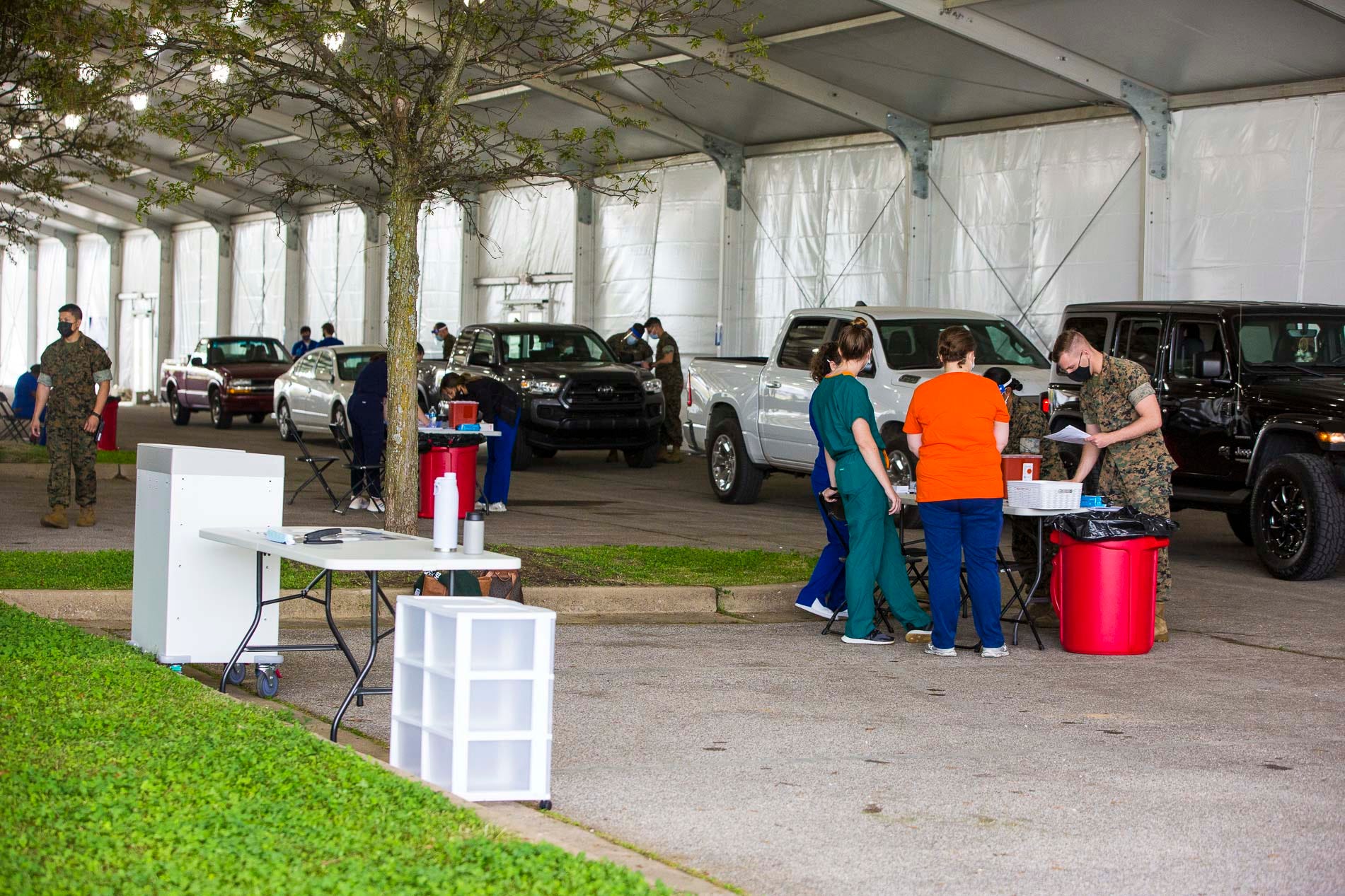 National Guard, volunteers, and medical staff assist people to vaccination areas near the Pipkin Building in Memphis on Wednesday, April 7, 2021.