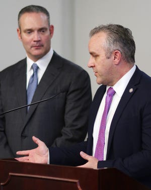 House Speaker Charles McCall listens to Senate Pro Tem Greg Treat during a news conference last year.