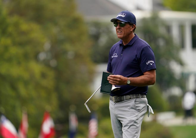 Apr 8, 2021; Augusta, Georgia, USA; Phil Mickelson checks his yard book on the 1st hole during the first round of The Masters golf tournament. Mandatory Credit: Rob Schumacher-USA TODAY Sports
