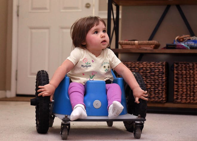 Clara Pedersen, 2, sits in her walker in their Reno home on April 8, 2021. Clara has Spinal Muscular Atrophy. The Reno family is trying to raise $2.2 million or get their insurance to cover a drug to save their daughter. SMA causes irreparable damage to the spinal nerves, and without treatment makes walking, sitting and even breathing or swallowing impossible.