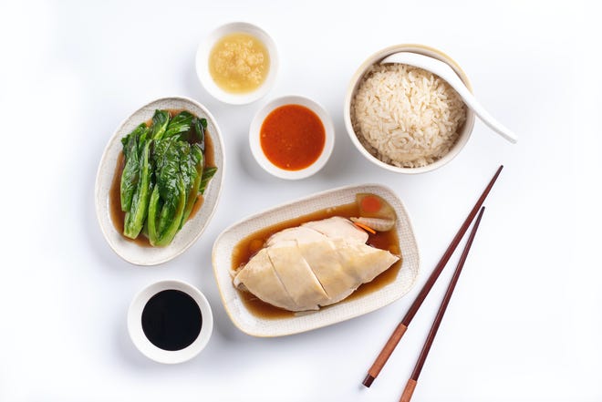 Traditional Hainanese chicken rice – poached chicken paired with rice cooked in chicken broth – based on recipes from Singapore's Chinatown in 1979.