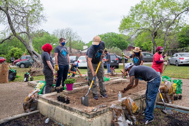 Employees and volunteers at LCRA work on a garden at in River City Youth Foundation in Austin on Friday, April 9, 2021. The event is a part of LCRA's annual Steps Forward Day where employees and volunteers work on community projects in both Travis and Williamson countries. 