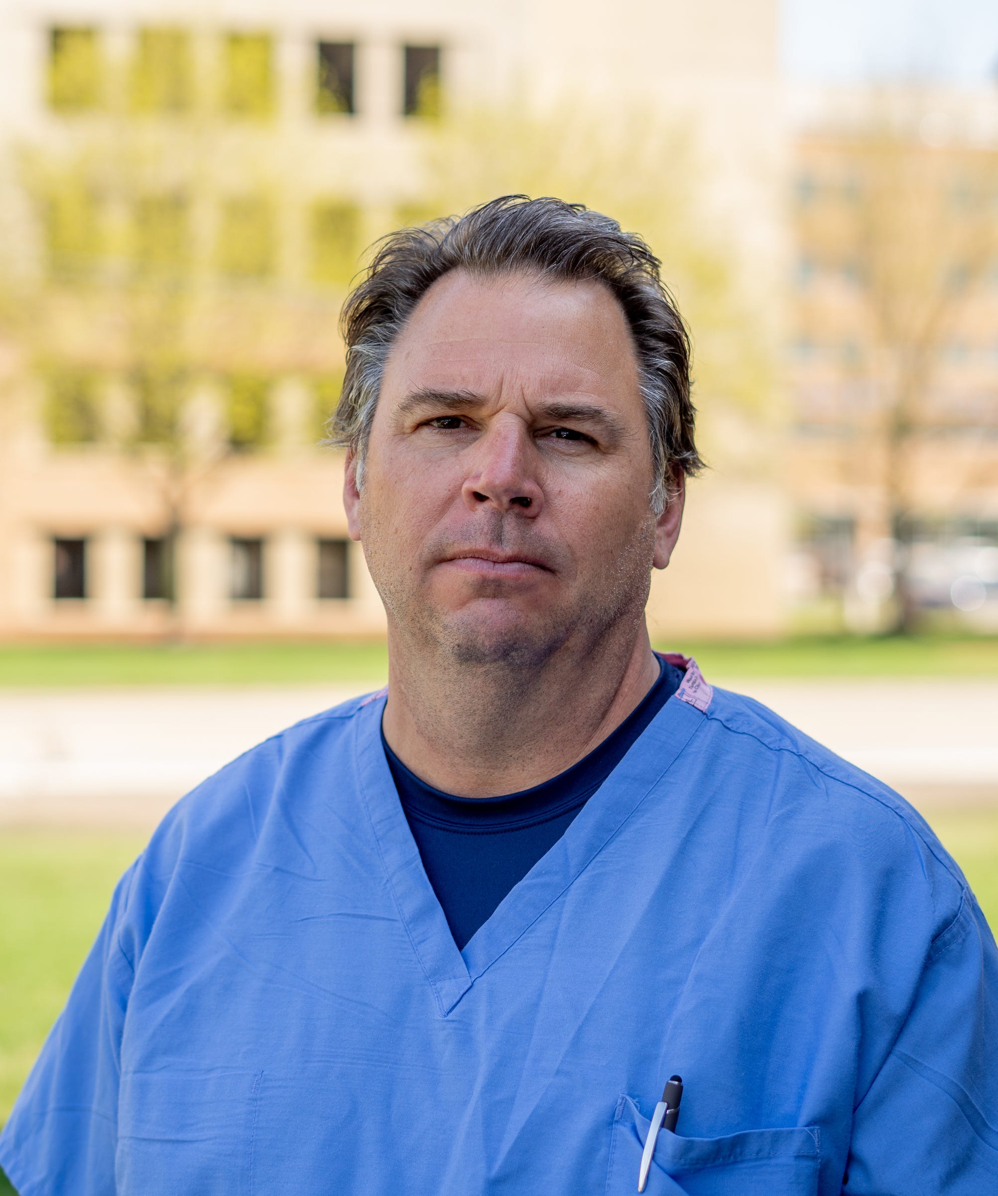 McLaren Macomb nurse Jeff Morawski stands outside of McLaren Macomb Hospital in Mt. Clemens on Friday, April 9, 2021. Morawski, who is President of the OPEIU Local 40, is one of the countless health care workers feeling overwhelmed.
