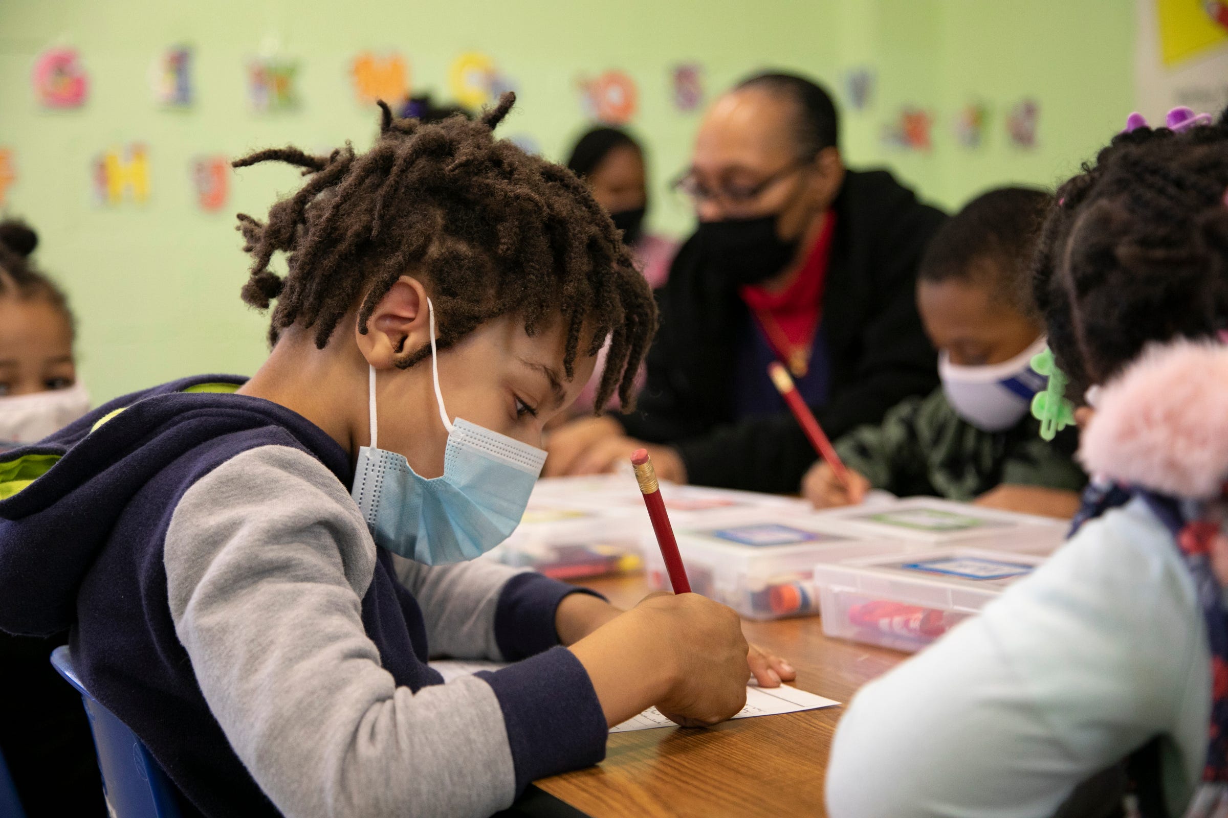 Corey Jones, 4, of Detroit, focuses on writing his name during class at the Franklin Wright Settlements that turns 140 this year. The organization is all about helping Detroiters with basic life, social, and family needs. We visit the early education arm of the organization in Detroit on Mar. 11, 2021.