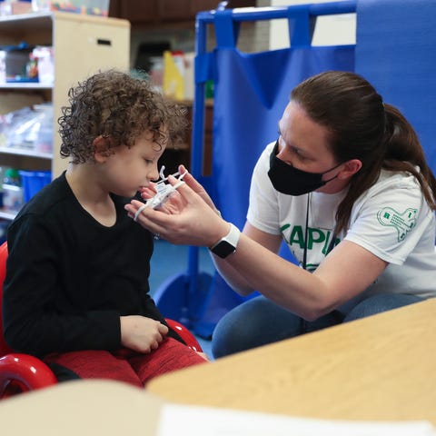 Teacher Katie Galvin, right, helps her student Bra