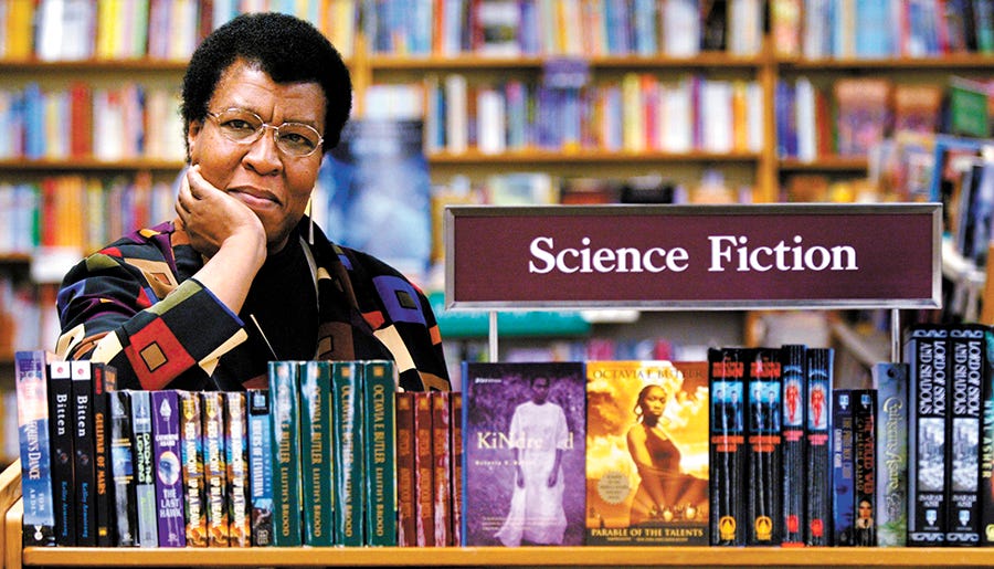 Author Octavia Butler poses near some of her novels at University Book Store in Seattle, Wash., on Feb. 4, 2004.