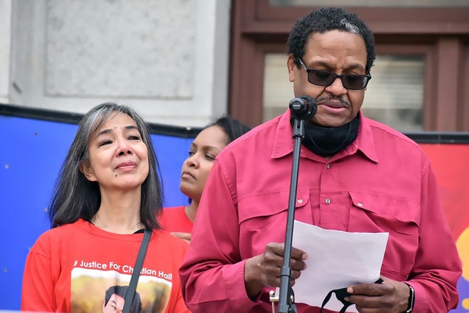 Gareth Hall addresses a crowd in Philadelphia with his wife Fe at his side.  Christian Hall's father, 19, says he feels "overwhelmed" by the number of voters who turned out to vote at Saturday's rally.  Hall was shot and killed by the Penn State Trooper in Poconos while experiencing what attorneys are calling "mental health crisis."