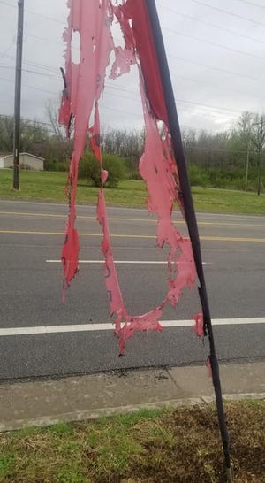 Shavonn "Nanny" Smith arrived Wednesday to find an arsonist had torched this advertising banner in front of her business, Nanny's Soul Food at 2410 S.E. 6th Ave.