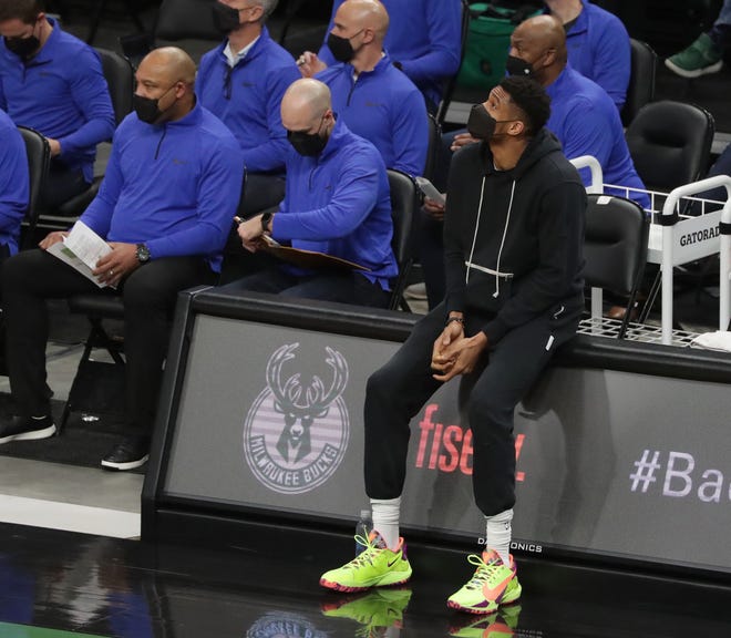 Bucks forward Giannis Antetokounmpo watches from the bench in a game against Charlotte.