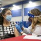 Pharmacist Aura Jessica Ruiz administers the Johnson & Johnson COVID-19 vaccine to a community member at the South Mountain Community College in Phoenix on April 10, 2021.