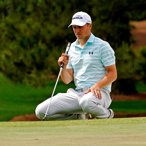 Jordan Spieth lines up his putt on the seventh gre