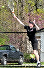 Ashland's Seth Karnosh returns a shot against Shelby during a doubles match at the Ashland Invitational Saturday at Brookside Park.