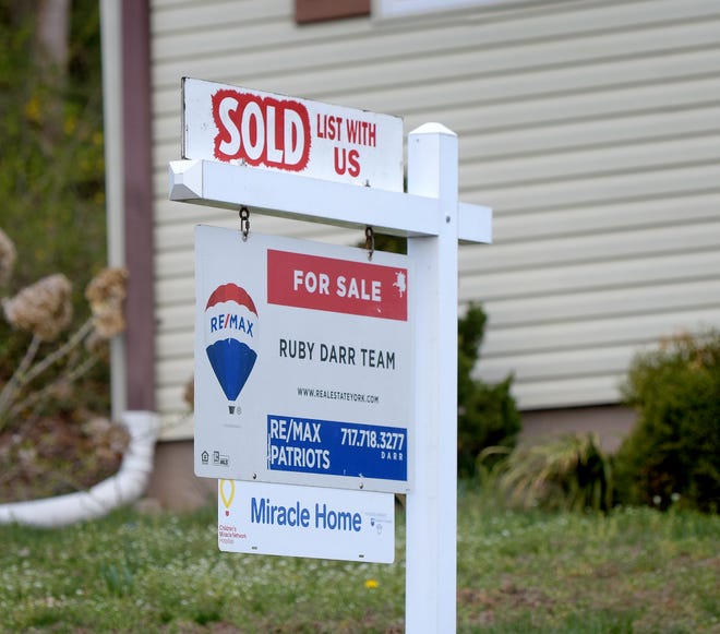 A "sold" sign sits outside a home on Park Street in Loganville Sunday, April 11, 2021. Bill Kalina photo