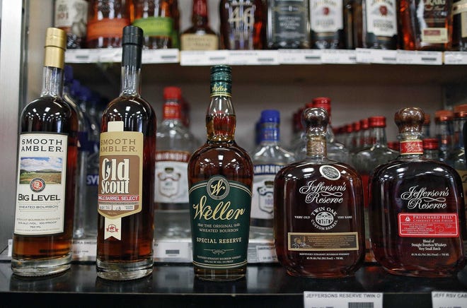 Hard-to-find bottles of whiskey sit behind the counter at Weiland's Market in Columbus in 2019.