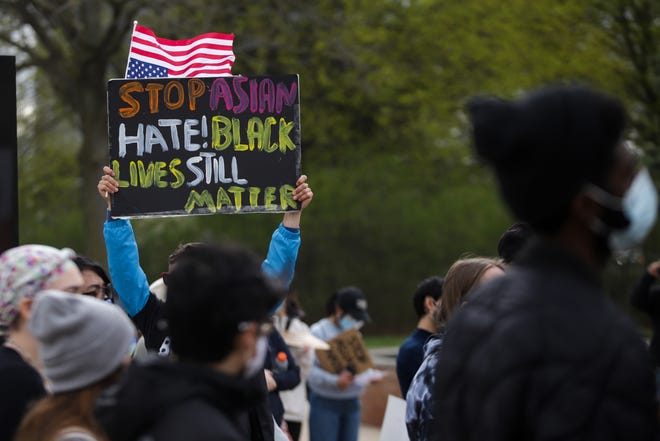 Jimmy Thomas, of Sterling Heights, holds up a sign during a rally against racism towards people of Asian descent at Troy City Hall on Sunday, April 11, 2021, in Troy. The event was held through Whenever We're Needed Detroit and Asian  & Pacific Islander American Vote - Michigan.