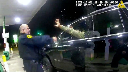 In this image made from Windsor Police video, a police officer uses a spray agent on Caron Nazario on Dec. 20, 2020, in Windsor, Va.