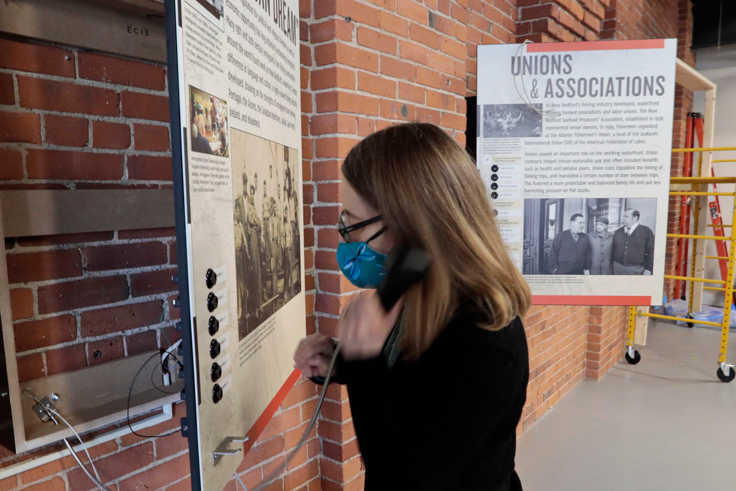 Laura Orleans, director, tests out one of the many new audio content stations being installed inside of the New Bedford Fishing Heritage Center on Bethel Street in New Bedford, which is undergoing major renovations including More than a Job: Work and Community in New Bedford's Commercial Fishing Industry. The new exhibits are scheduled to open soon.