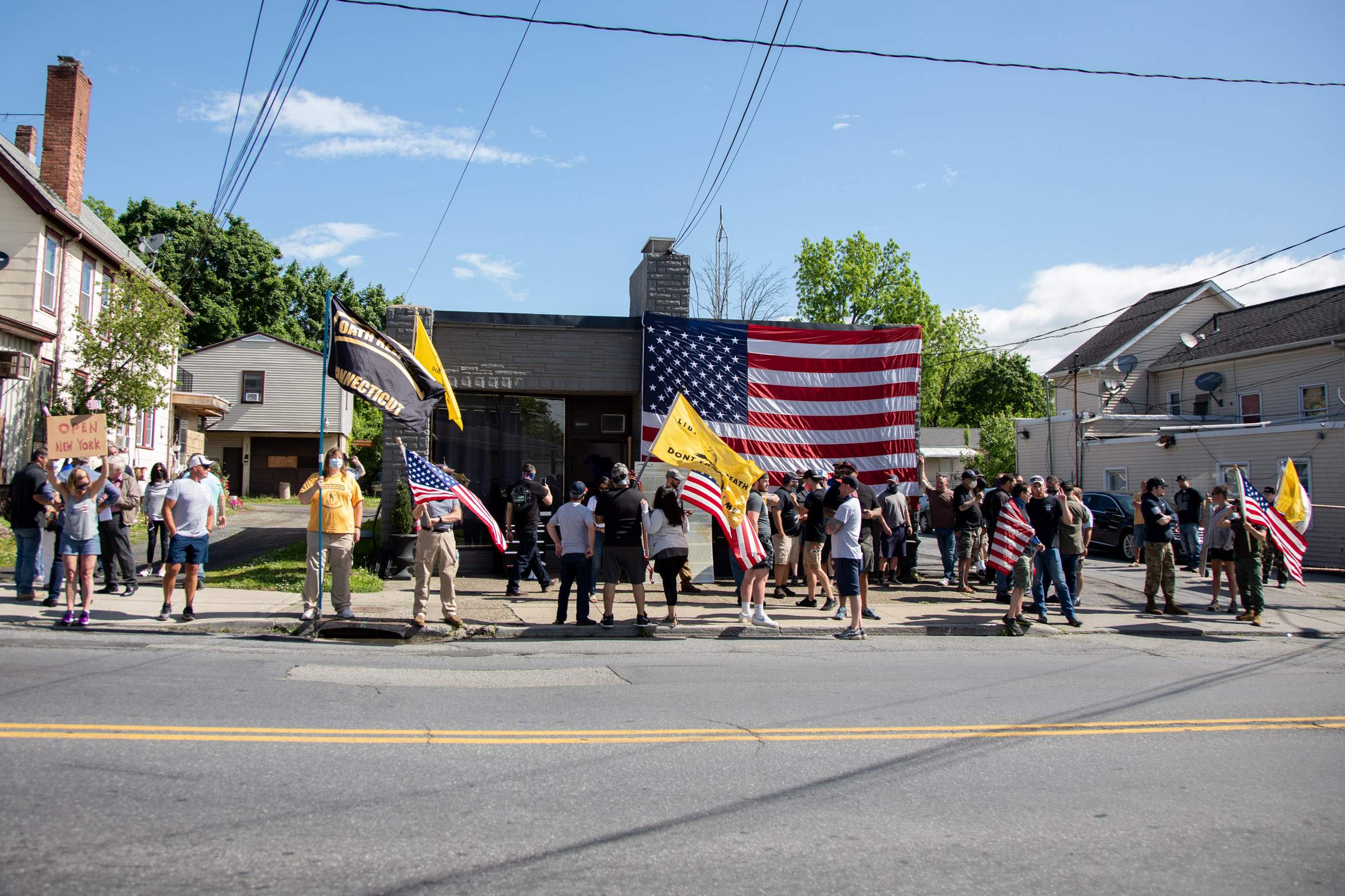 People participate in a rally outside tattoo shop Casa di Dolore in Newburgh on Saturday, May 30, 2020.