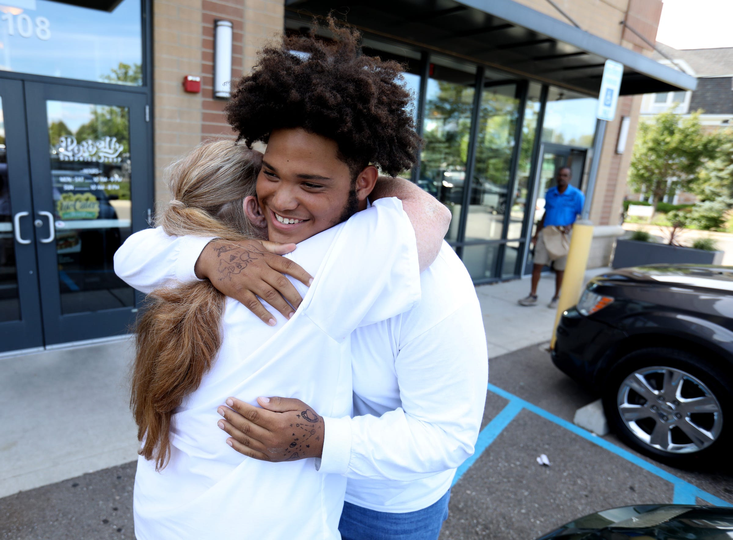 Edith Turner and her son, De'Antwan Franklin, hug for the first time in more than 10 years in the parking lot of a Starbucks in Bloomfield Township, Mich., on Tuesday, September 24, 2019. Franklin was 4 years old when he last saw his mom. They kept up their relationship while Turner was incarcerated, staying connected with 15-phone calls, photos and handmade cards.