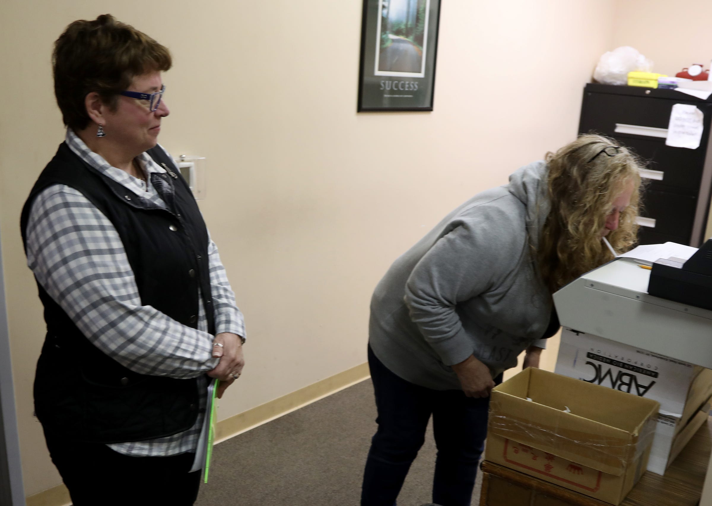 Parole officer Amy Lumley monitors as Edith Turner takes a breathalyzer test during a check-in at the parole office in Pontiac on Wednesday, October 16, 2019.