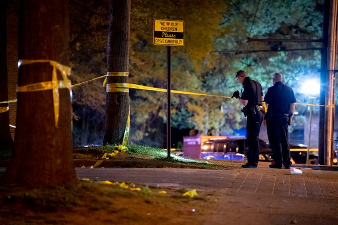 Metro Nashville Police investigate the scene of a shooting which left two adults and two children shot on 25th Avenue North in the North Nashville neighborhood of Nashville, Tenn., Monday, April 12, 2021.