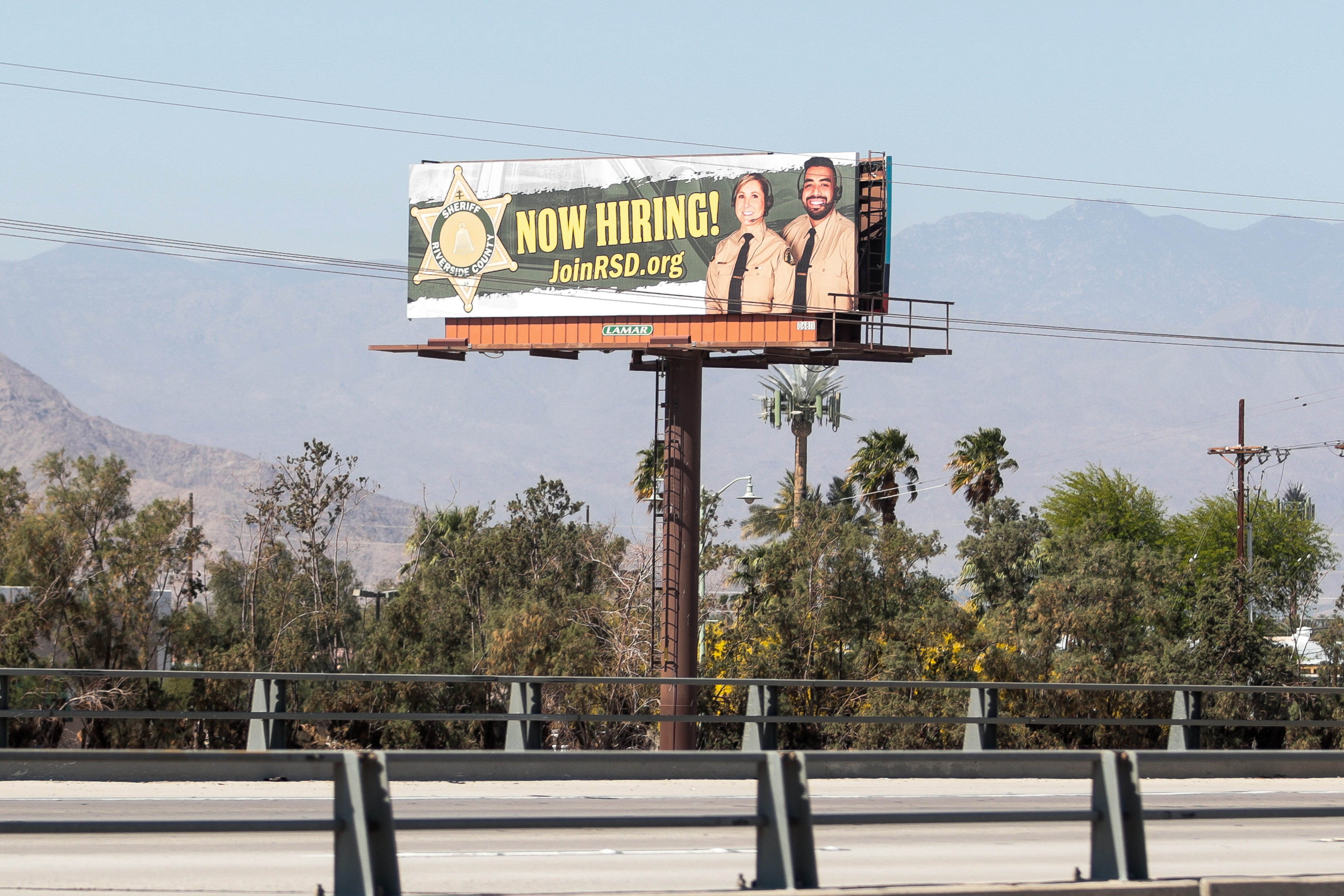 A billboard advertising jobs with the Riverside County Sheriff's Department sits off Interstate 10 near Thermal in 2021.