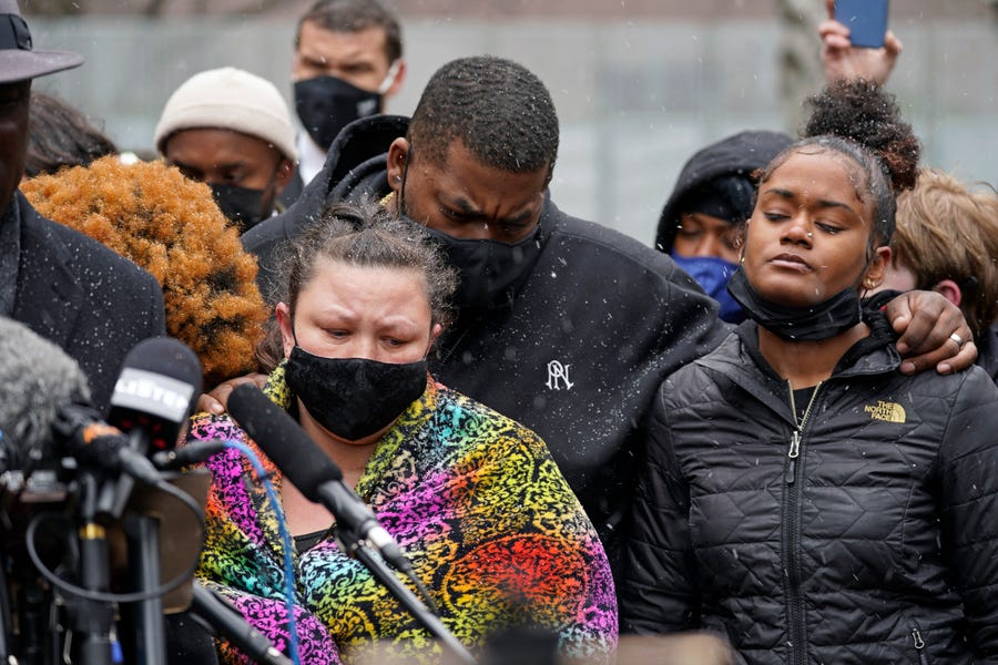Katie Wright, left, the mother of Daunte Wright, and other family and friends gather during a news conference Tuesday, April 13, 2021, in Minneapolis as family attorney Ben Crump speaks. Daunte Wright, 20, was shot and killed by police Sunday after a traffic stop in Brooklyn Center, Minnesota.