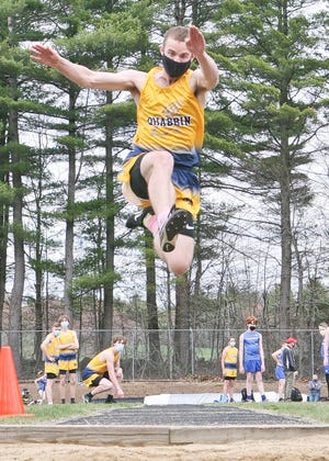 Quabbin's Brett Earle launces himself toward the sand pit while competing in the long jump during Tuesday afternoon's meet against Murdock in Winchendon.