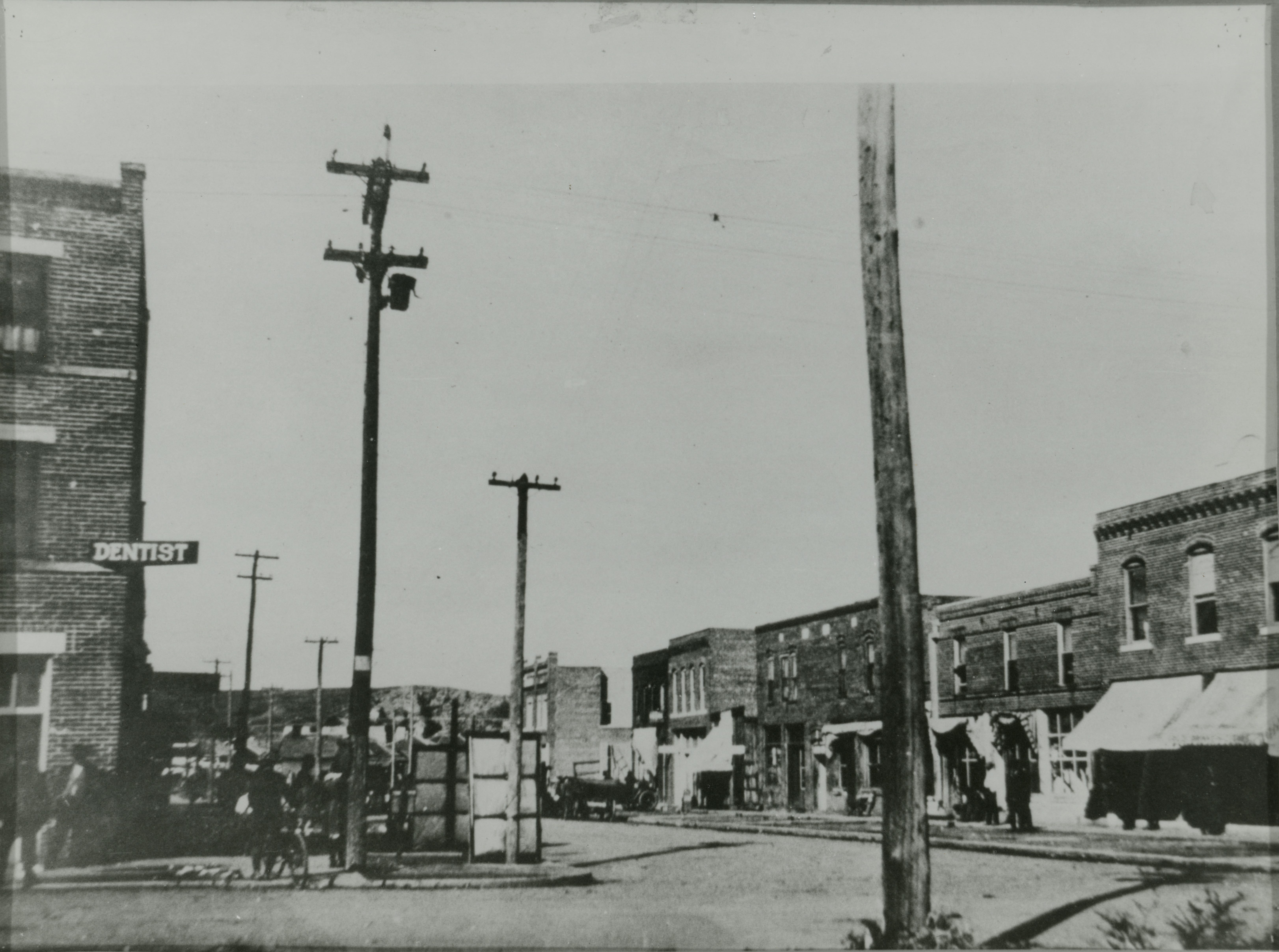 The image shows many buildings later destroyed in the 1921 Tulsa Race Massacre. The building on the far left is the Williams Building. The sign for dentist J. J. McKeever is visible. On the right side of the street (looking North toward Brickyard Hill) is the Bryant Building, Howard Building, Hardy Building, Gist Building, Nichols Building and the Dreamland Theatre.